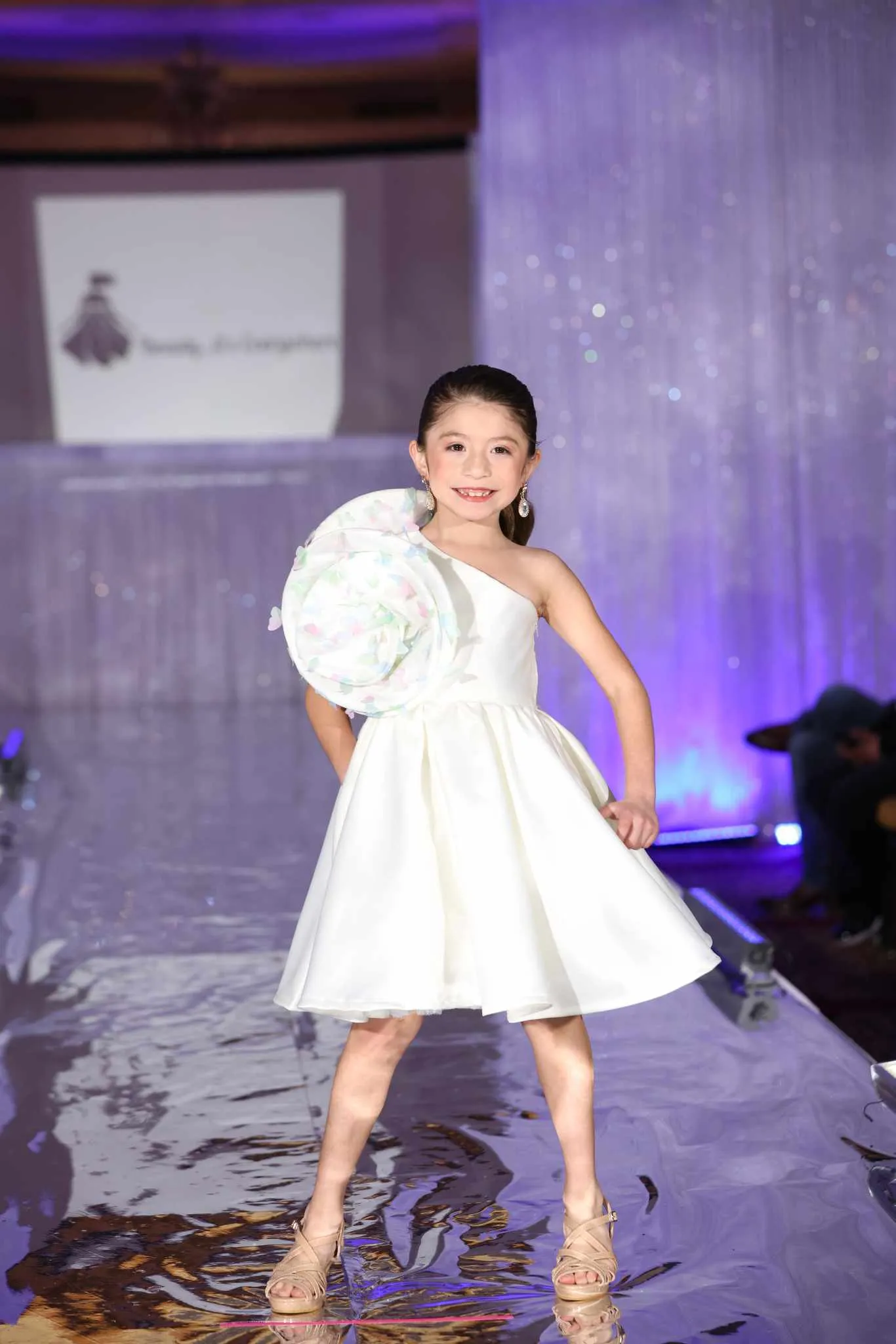 Model on the runway wearing the Butterfly Swirl Dress by Babs Boutique